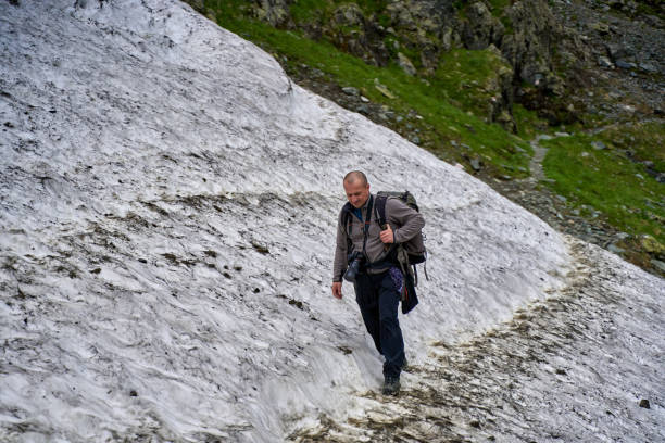 istock Hiker on the summer snow trail 1264558464