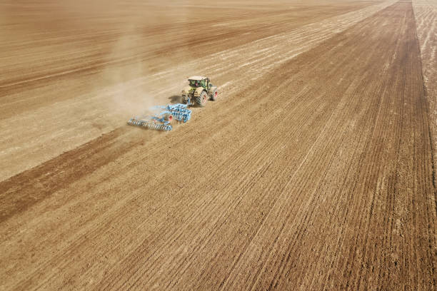 istock Aerial view Tractor preparing field, Agriculture tractor landscape 1264559413