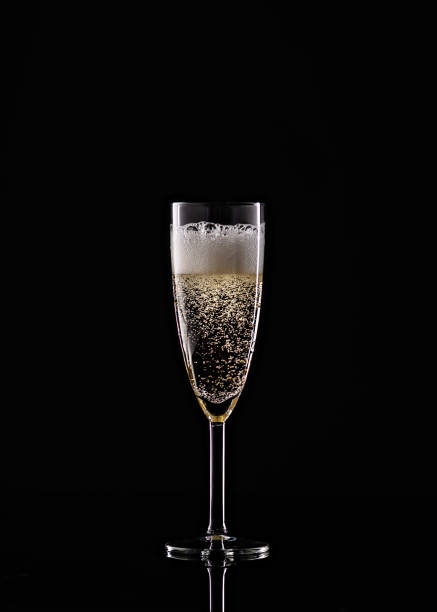 istock full champagne glass on black background 1264561785