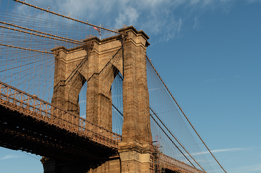 A close-up of the arcs of the Brooklyn Bridge as seen from the Manhattan side on a beautiful sunny day.