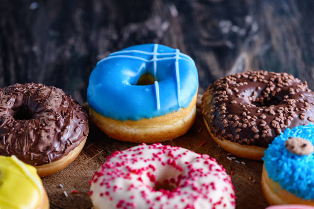 istock Glazed donuts on wooden background 1264563578
