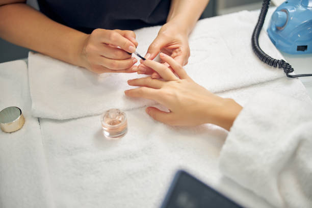 istock Nail artist doing manicure with gel for client 1264568150