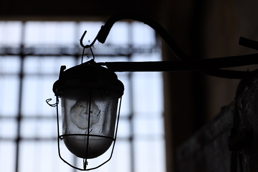 The old lamp hangs in the factory