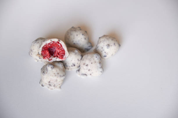 Whole and halved raspberries dipped or covered in vegan dark chocolate, white and cookies, milk chocolate and white chocolate.