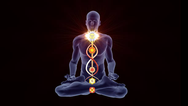 Silhouette in lotus pose with five Chakras stock photo