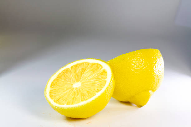 istock Lemon sliced into half isolated; yellow juicy lemon half isolated 1264572720