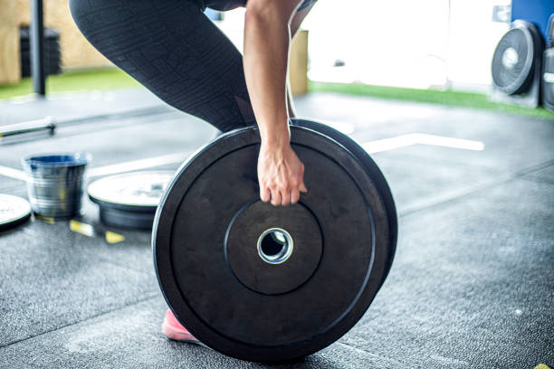 Woman picking up weights in gym