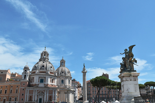 Rome panorama: domes and statues with partly cloudy sky.