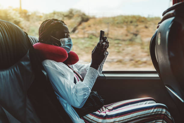 Black girl is phoning in regular bus