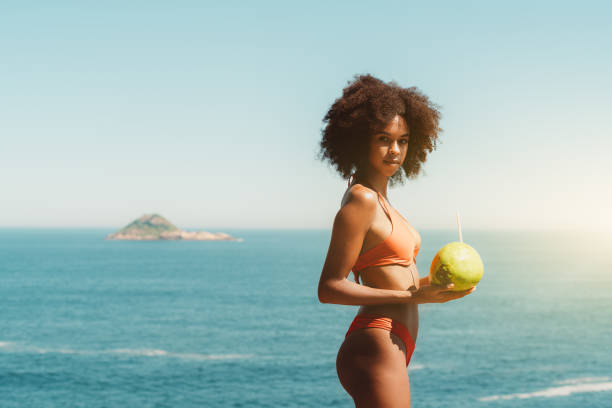 istock Brazilian girl with coconut, beach 1264576403