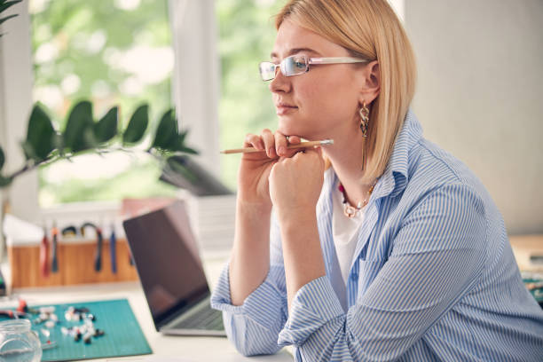 istock Pensive casually dressed woman looking through spectacles 1264578036