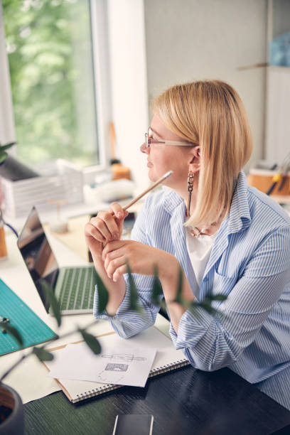 istock Calm office employee keeping elbows on table 1264578045