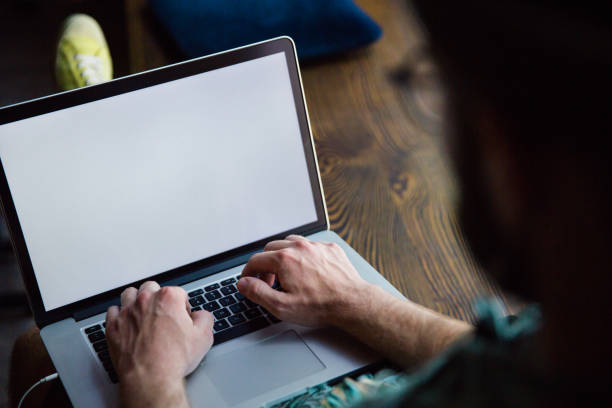 istock Closeup view of male hands typing on laptop with white empty screen 1264580587