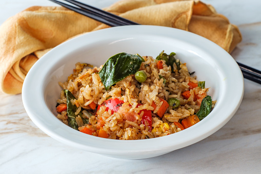 Thai spicy fried rice with kaffir lime leaves and chop sticks