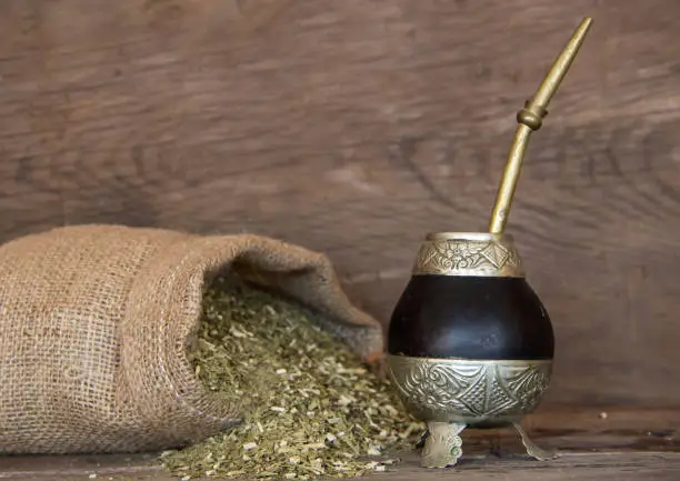 Mate and yerbamate on rustic wooden background. Traditional South American infusion