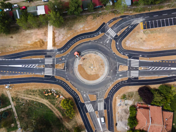 istock Top down aerial drone view on traffic roundabout road under construction in summer day - Brza Palanka Town in Serbia main road from air - connecting freedom travel and destination concept crossroad 1264582676