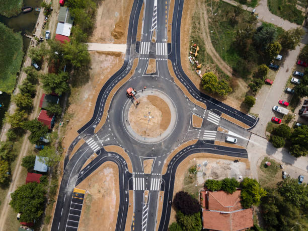 Top down aerial drone view on traffic roundabout road under construction in summer day - Brza Palanka Town in Serbia main road from air - connecting freedom travel and destination concept crossroad