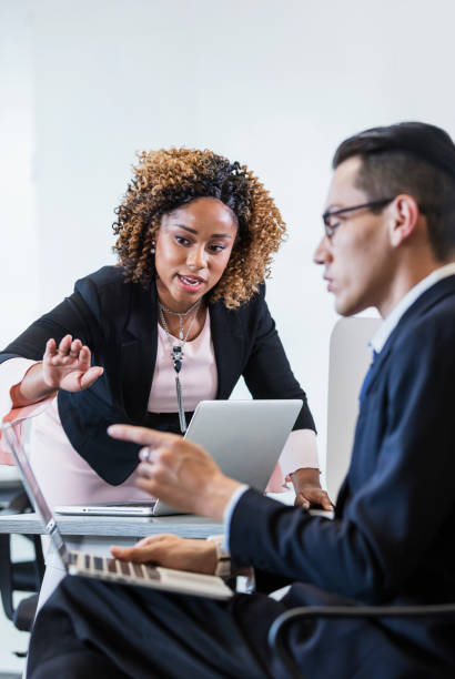 istock Two business people working in office, talking 1264586744