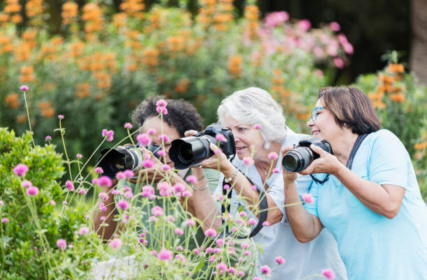istock Three senior women taking photos in garden 1264587738