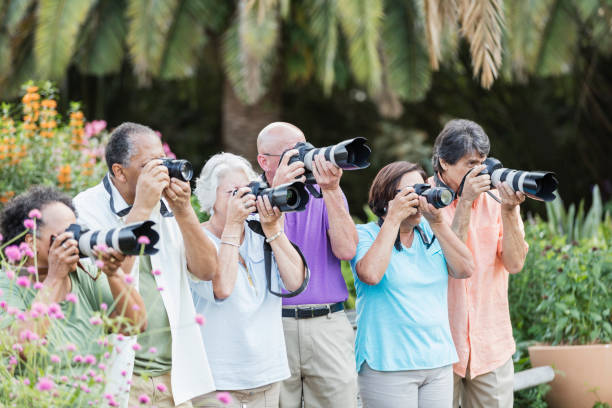 istock Group of seniors on sightseeing tour with cameras 1264587739