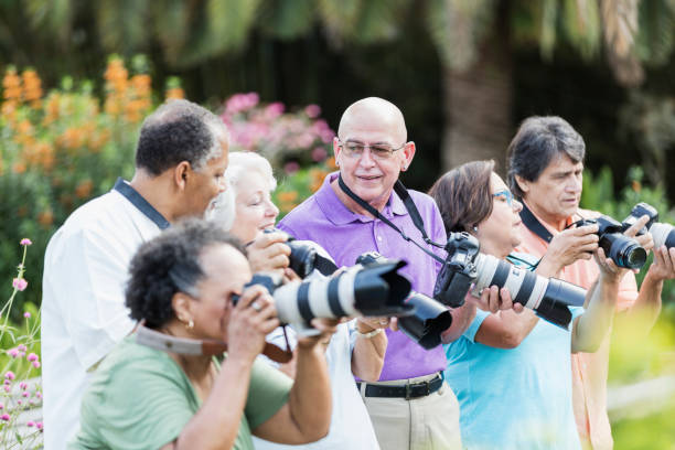 istock Group of seniors on sightseeing tour with cameras 1264587784