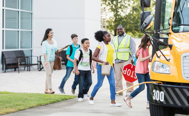 istock Students and teacher boarding school bus 1264589210