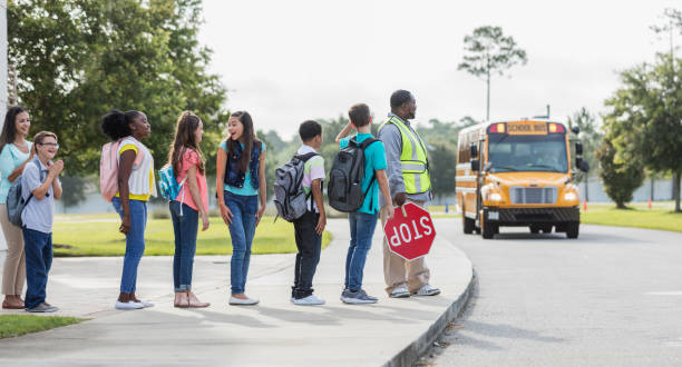 istock Middle school class wait for bus, boy with down syndrome 1264589872