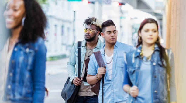 istock Multi-ethnic young adults walking in the city, strangers 1264591456