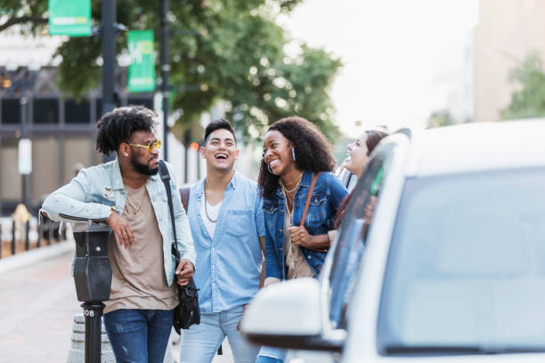 istock Multi-ethnic young adults in city, conversing 1264591649