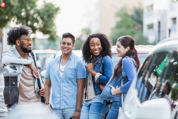 istock Multi-ethnic young adults in city, conversing 1264591650