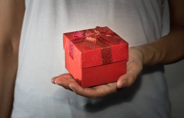 istock Female holding red present box in hand. 1264594558