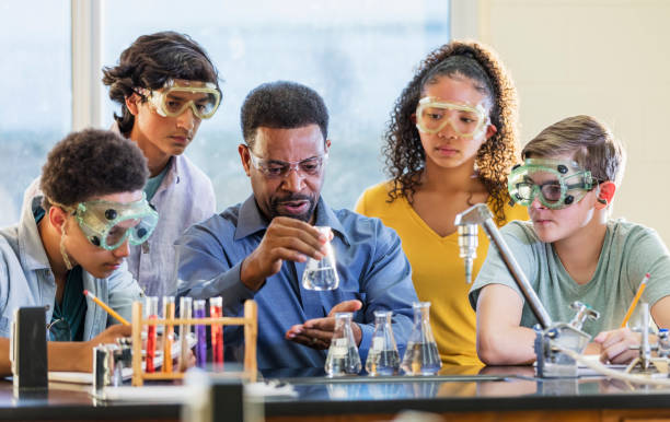 istock Multi-ethnic teacher and students in chemistry lab 1264595271