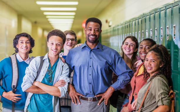 istock Teacher and high school students hanging out in hallway 1264595506
