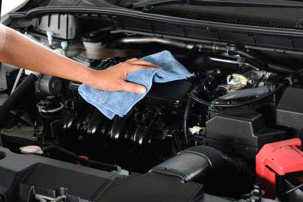 hand of a man holding a blue cloth caring, maintenance car and cleaning And engine car room stock photo