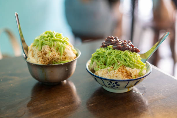 Cendol and Ice Kacang - Malaysian shaved ice dessert Cendol and Ice Kacang - Malaysian shaved ice dessert on top of wooden table coconut milk photos stock pictures, royalty-free photos & images