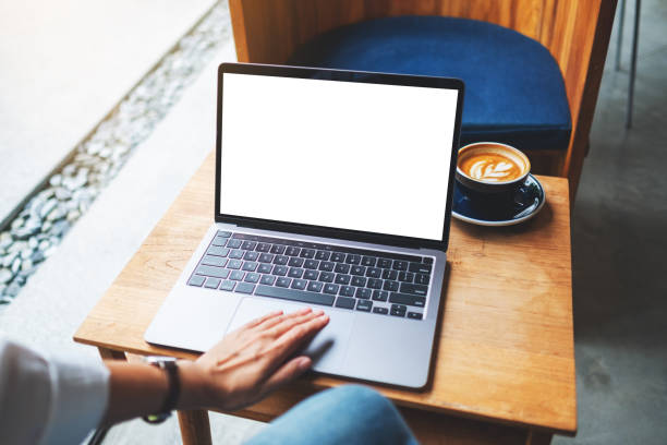 istock a woman using and touching on laptop touchpad with blank white desktop screen on wooden table 1264603769