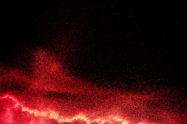 istock Red powder explosion on black background. Freeze motion of red dust particles splash. 1264613565