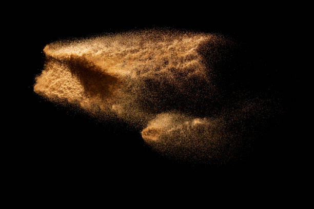istock Brown colored sand splash.Dry river sand explosion isolated on black background. 1264613572