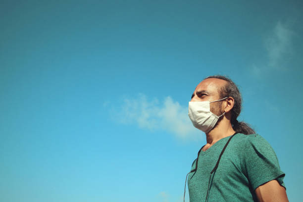 istock Man covering his face with pollution mask for protection from viruses 1264613623