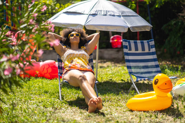 Back yard staycation Young afro girl sunbathing in the back yard staycation photos stock pictures, royalty-free photos & images