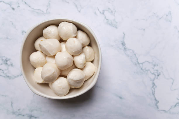 istock Boiled fish balls in white bowl on marble table background. 1264614731
