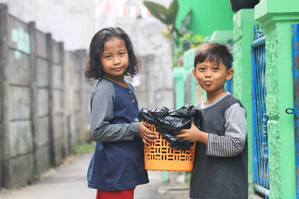 2 Children learn to take out kitchen trash.