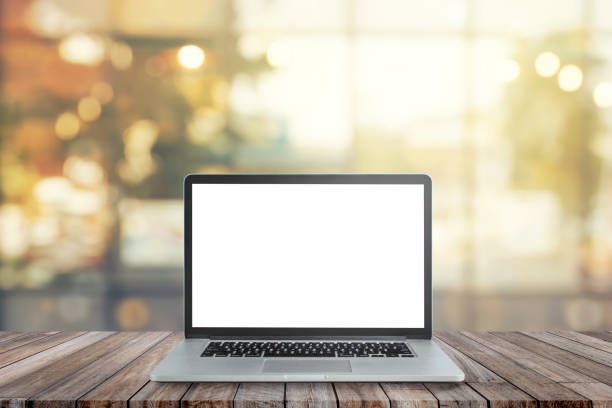 istock Black laptop with blank white screen on wooden table. 1264622077