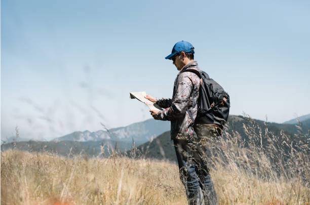 istock Man Hiking On Field Against Mountains 1264623854