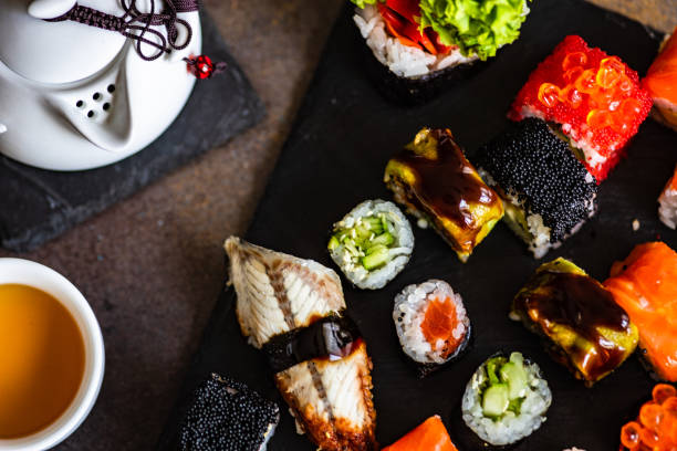 istock Sushi Set sashimi and sushi rolls served on stone slate 1264625051