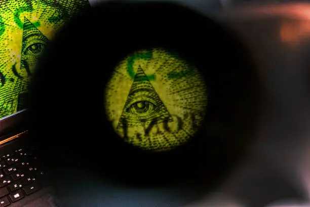 dollar pyramid under magnifying glass green