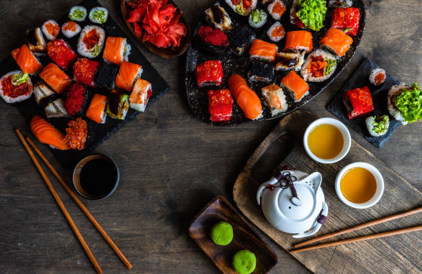 istock Sushi Set sashimi and sushi rolls served on stone slate 1264625417