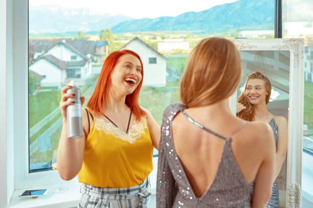 istock Best friend helping blond with hairstyle before prom 1264626722