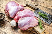 Raw Turkey thigh fillet with spices for cooking. Wooden background. Top view
