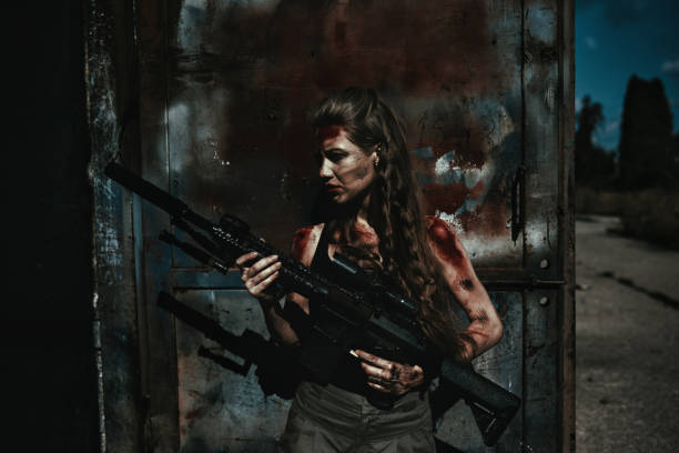 Protecting and feeling ready to attack Female warrior with huge riffle and physical wounds protecting property female sharp shooter stock pictures, royalty-free photos & images